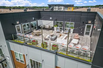 an aerial view of a rooftop patio with tables and chairs